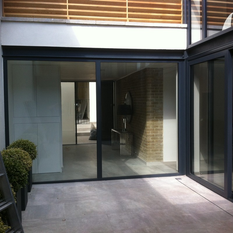 Floor-to-ceiling sliding doors opening to courtyard in Brent Cross