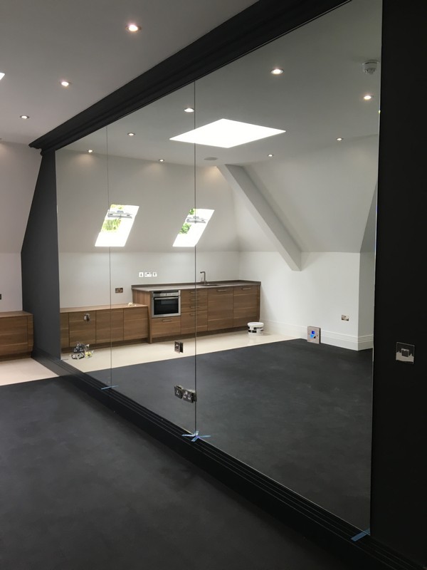 Frameless glass partition in loft conversion by Brent Cross glaziers