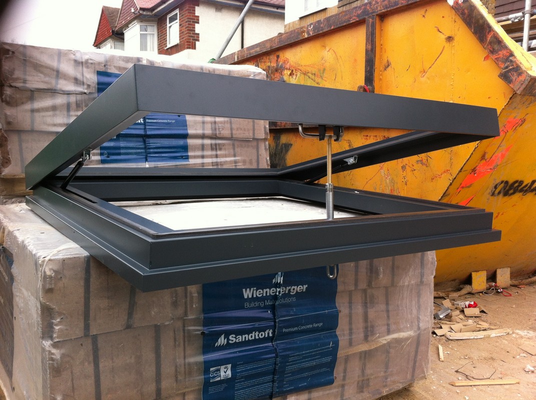 Opening flat roof skylight in anthracite grey installed in Brent Cross